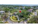 Bird's eye view showcasing a home in a leafy neighborhood with mature trees and winding roads at 5001 W Dickens Ave, Tampa, FL 33629