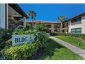 Condo exterior with lush tropical landscaping and sidewalk leading to entrance at 502 Hammock Pine Blvd # 502, Clearwater, FL 33761