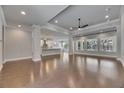 Bright and open living space with hardwood flooring and large windows offering natural light throughout at 5316 Candler View Dr, Lithia, FL 33547