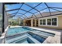 This amazing covered lanai features a large in ground pool, hot tub and an outdoor cooking area at 5316 Candler View Dr, Lithia, FL 33547