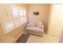 Cozy sitting area featuring plantation shutters and a comfortable loveseat with neutral decor at 6060 Shore S Blvd # 302, Gulfport, FL 33707