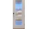 Modern front door with a vertical window panel and a smart lock offers both style and security at 6398 Bradford Woods Drive, Zephyrhills, FL 33542