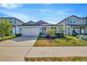 Charming single Gathering home boasting lush landscaping, a paver driveway, and an attached two-car garage at 6398 Bradford Woods Drive, Zephyrhills, FL 33542