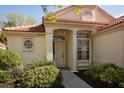 Inviting front entrance with a round window and a meticulously kept garden at 717 Lighthouse Dr, Tarpon Springs, FL 34689
