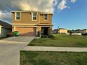 Charming two-story home with a two-car garage, manicured lawn, and inviting entrance at 7530 Broad Pointe Dr, Zephyrhills, FL 33540