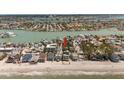 Expansive aerial view showcases beachfront property on a picturesque shoreline, ideal for coastal living at 8403 W Gulf Blvd, Treasure Island, FL 33706