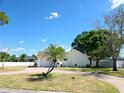 Lovely single-story home featuring a brick driveway, a mature palm tree, and manicured front lawn at 8719 Sunlit Cove Ne Dr, St Petersburg, FL 33702