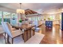 Open-concept kitchen and dining area boasts a wooden dining table, hardwood floors, and a fireplace at 898 Cypress Lakeview Ct, Tarpon Springs, FL 34688