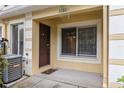 A welcoming front porch features a brown entry door, large window, and AC unit at 10807 Keys Gate Dr, Riverview, FL 33579