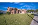 Inviting single-story home with lush green lawn, covered entryway, and attached two-car garage at 10841 Standing Stone Dr, Wimauma, FL 33598