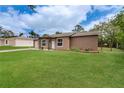 Charming single-story home with a well-maintained lawn, inviting entryway, and attached one car garage at 11396 Terrell Rd, Spring Hill, FL 34608