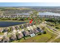 Wide aerial view of a Primary-planned community featuring lakes, walking trails, and well-maintained homes at 11407 Acacia Grove Ln, Riverview, FL 33579