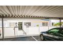 Condo complex featuring guest parking, well-maintained exteriors, and charming white picket fence at 1655 S Highland Ave # F126, Clearwater, FL 33756