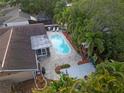 Aerial view of the home, pool, patio, lush landscaping, and outdoor living spaces, highlighting the property's appeal at 1686 Spottswood Cir, Palm Harbor, FL 34683