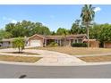 Charming single-story home featuring a well-manicured front lawn and a two-car garage at 1686 Spottswood Cir, Palm Harbor, FL 34683