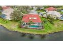 Aerial view of the property showcasing the pool, spa, screened enclosure, and waterfront location at 18002 Forest Retreat Ln, Tampa, FL 33647