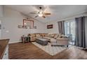 Living area features lots of natural light, wood-look floors, vaulted ceiling and neutral toned walls at 23253 Granite Pl, Land O Lakes, FL 34639
