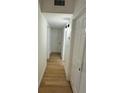 Hallway with multiple doors and wood flooring at 26448 Eager Rd, Punta Gorda, FL 33955