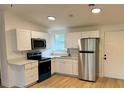 Bright kitchen featuring stainless steel appliances, white cabinetry, and light countertops at 26448 Eager Rd, Punta Gorda, FL 33955