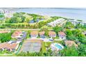 Scenic aerial view showcasing the community's pool, golf course, tennis courts, and proximity to Tampa Bay at 2933 Bough Ave # C, Clearwater, FL 33760