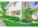 Beautiful condo boasts a well-maintained exterior, a welcoming door, and lush, mature landscaping at 2933 Bough Ave # C, Clearwater, FL 33760