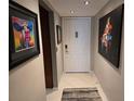 Inviting entryway featuring neutral walls and striking artwork, setting a welcoming tone to the home at 3062 Eastland Blvd # 105, Clearwater, FL 33761