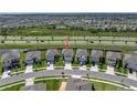 An aerial view shows this home in a community setting, positioned with easy access to the main road at 30739 Penny Surf Loop, Wesley Chapel, FL 33545