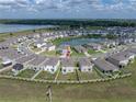 This aerial shows the property's location within a residential area near a pond and community amenities at 30739 Penny Surf Loop, Wesley Chapel, FL 33545