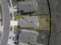 An aerial view shows property lines of the home, including the roof, driveway, and lawn areas at 30739 Penny Surf Loop, Wesley Chapel, FL 33545