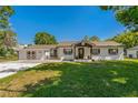 Charming single-story home with a well-manicured lawn and inviting front porch with decorative wreath at 3113 W Sligh Ave, Tampa, FL 33614