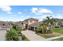 Aerial view of a well-maintained property with a spacious layout, a two-car garage and lush landscaping at 31382 Chesapeake Bay Dr, Wesley Chapel, FL 33543