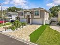 A beautiful two-story home with a paver driveway, a well-manicured lawn, and an attached garage at 314 Crosswinds Dr, Palm Harbor, FL 34683