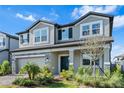 Attractive two-story home with a well-maintained lawn and a paver driveway, offering excellent curb appeal at 33263 Sycamore Leaf Dr, Wesley Chapel, FL 33545