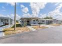 Charming single-story home featuring a covered parking area and a well-maintained yard at 37025 Lois Ave, Zephyrhills, FL 33542