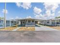 Charming single-story home featuring a covered parking area and a well-maintained yard at 37025 Lois Ave, Zephyrhills, FL 33542