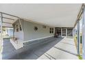 A well-lit, covered parking area provides ample space, adjacent to the home's exterior at 37025 Lois Ave, Zephyrhills, FL 33542