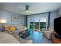 Inviting living room with contemporary furnishings and a sliding glass door to the balcony at 4900 Brittany S Dr # 502, St Petersburg, FL 33715
