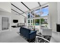 Bright living room with high ceilings, large windows overlooking the pool, and a stylish seating area at 5018 S The Riviera St, Tampa, FL 33609