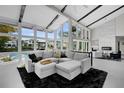 Spacious living room with vaulted ceilings, contemporary decor, fireplace, and large windows offering scenic views at 5018 S The Riviera St, Tampa, FL 33609
