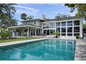 Stunning backyard oasis with a large swimming pool, covered patio, and ample space for entertaining at 5018 S The Riviera St, Tampa, FL 33609