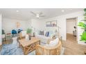 Bright living room with a ceiling fan, comfortable seating, and stylish decor, creating an inviting atmosphere at 5094 Starfish Se Dr # E, St Petersburg, FL 33705