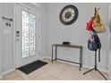 A stylish entryway showcases tiled floors and features a decorative glass door and modern accents at 5108 Suncatcher Dr, Wesley Chapel, FL 33545
