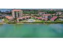 Aerial view showcasing the waterfront condo community with a swimming pool and lush surroundings at 6322 Palma Del Mar S Blvd # 706, St Petersburg, FL 33715