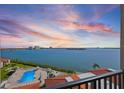 Breathtaking balcony view of the tranquil waterfront, city skyline, and community pool at 6322 Palma Del Mar S Blvd # 706, St Petersburg, FL 33715