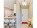 Inviting entryway featuring neutral tones, ceramic tile, and modern lighting that seamlessly connects the kitchen and living areas at 6333 Milestone Loop, Palmetto, FL 34221