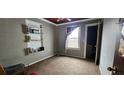 This bedroom features built-in bookshelves, a window letting in light, and convenient access to a closet at 702 Whitehurst Rd, Plant City, FL 33563