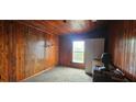 This cozy bedroom offers wood paneled walls and ceiling, a window and closet space for convenient storage at 702 Whitehurst Rd, Plant City, FL 33563