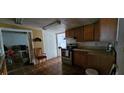 This kitchen boasts wooden cabinets, an oven, and good lighting, ready for Gathering meals at 702 Whitehurst Rd, Plant City, FL 33563