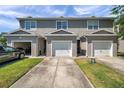 Townhome with attached garage, and well kept lawn offering a convenient and attractive living space at 7070 Opal Dr, Largo, FL 33773