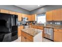 Bright kitchen with stainless appliances, island, granite countertops, and tile flooring at 7070 Opal Dr, Largo, FL 33773